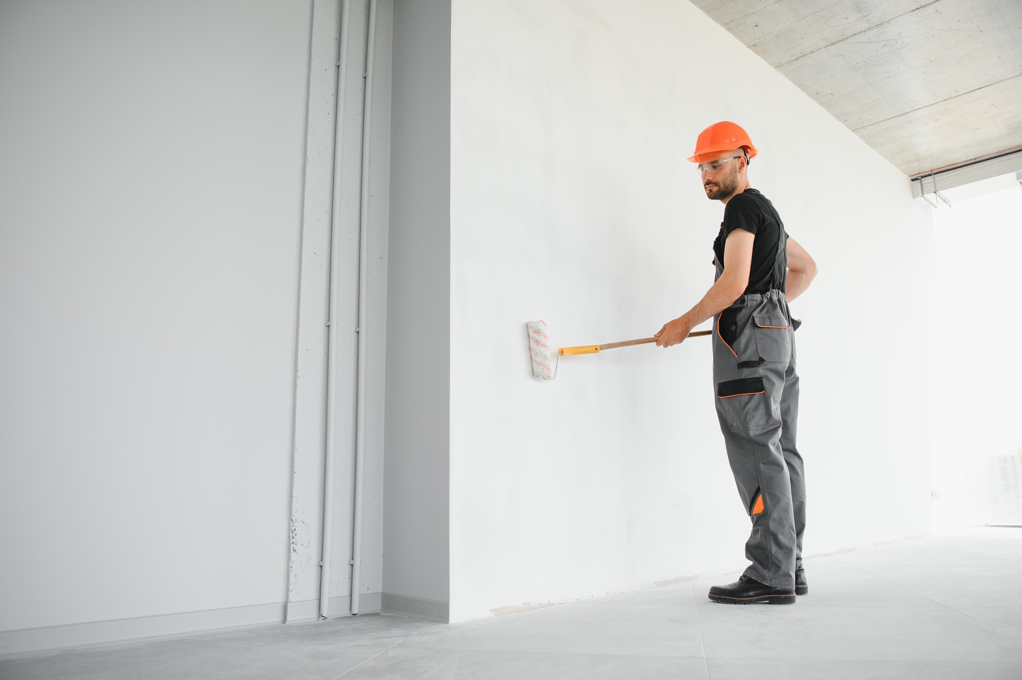 Male workers doing interior renovation in apartment.